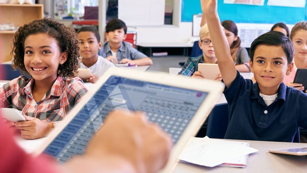 Teacher taking digital attendance on a tablet