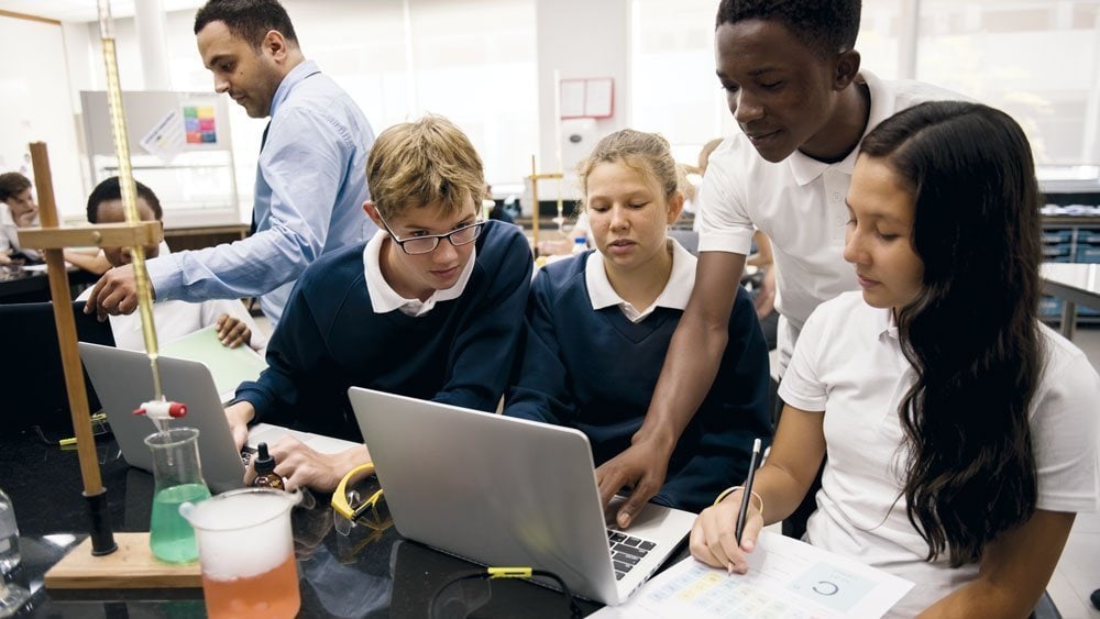 Students using laptops in science class