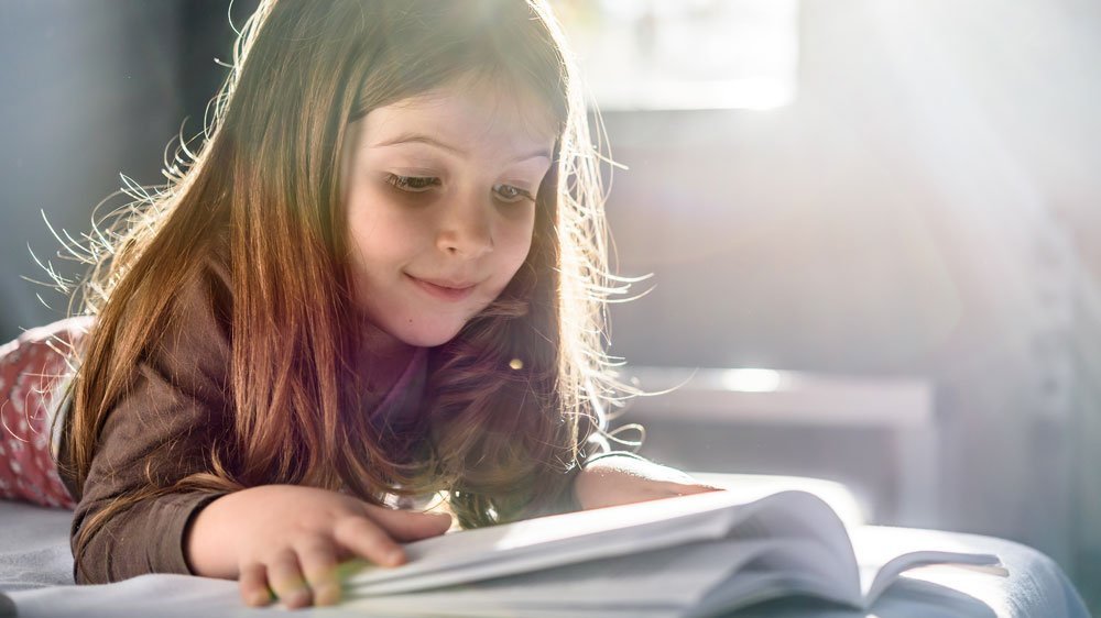 Little girl reading a book